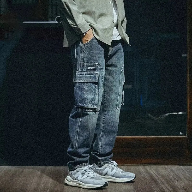 Men's blue loose straight retro style polyester denim trousers on a neutral background.