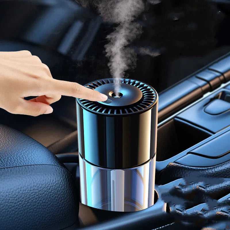 Compact USB plug-in spray perfume humidifier with glass seat on a desk.