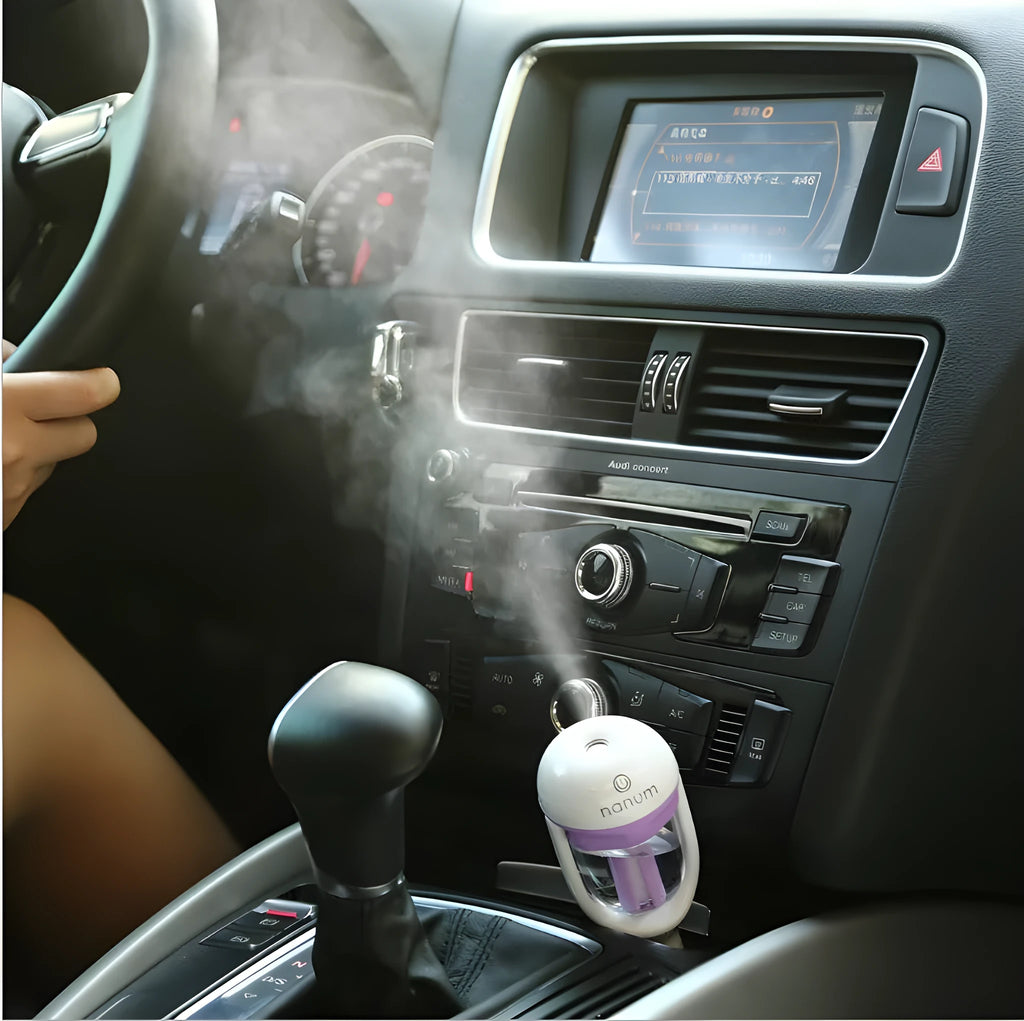 Compact blue car humidifier with essential oil diffuser function on car dashboard