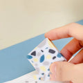 A rectangular brick-shaped white rubber eraser for removing pencil marks.