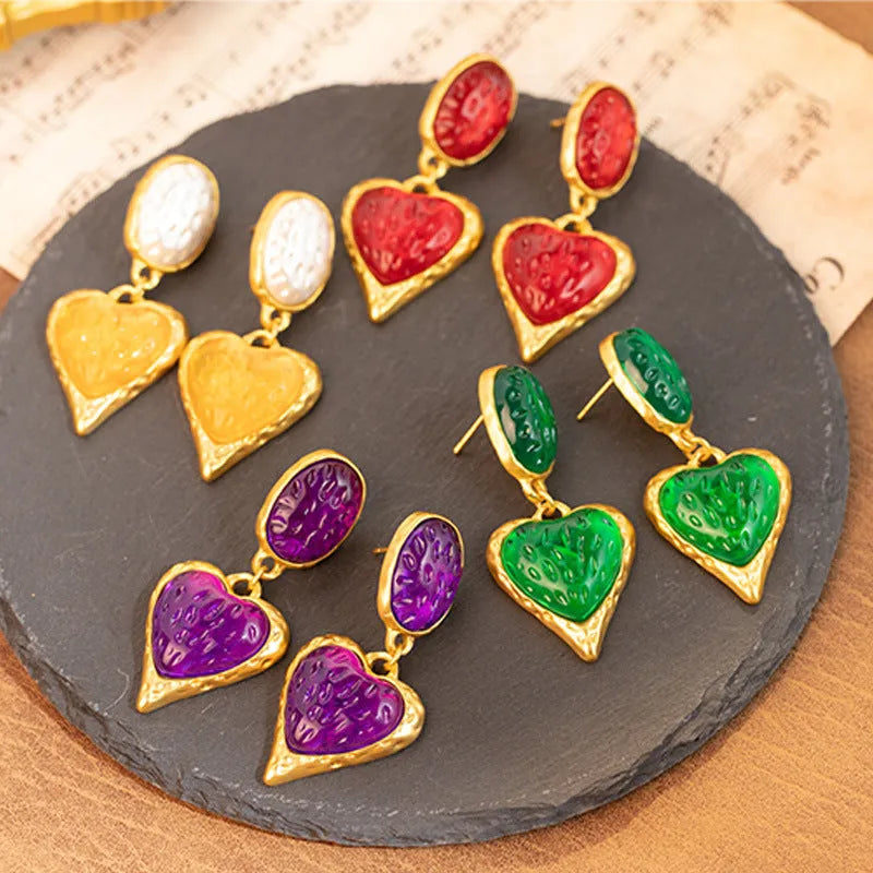 Silver needle pleated oval love heart alloy stud earrings in purple, red, green, and yellow and white colours.