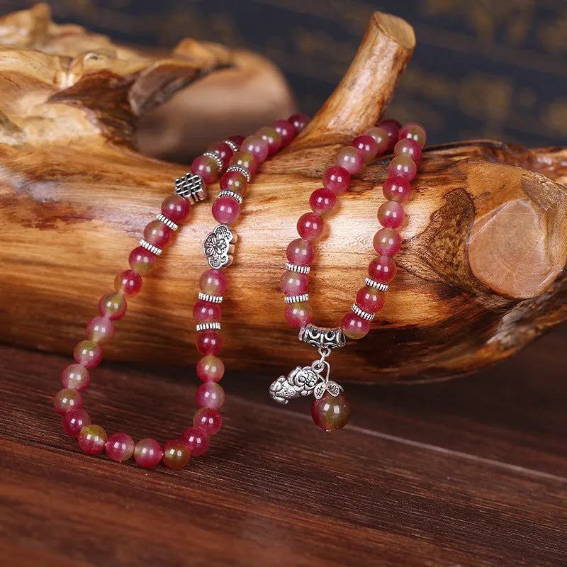 Natural watermelon crystal bracelet with Chinese knot fastening showing bi-colour gemstone beads
