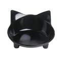 Shallow black melamine cat bowl with non-slip rubber base on a kitchen floor