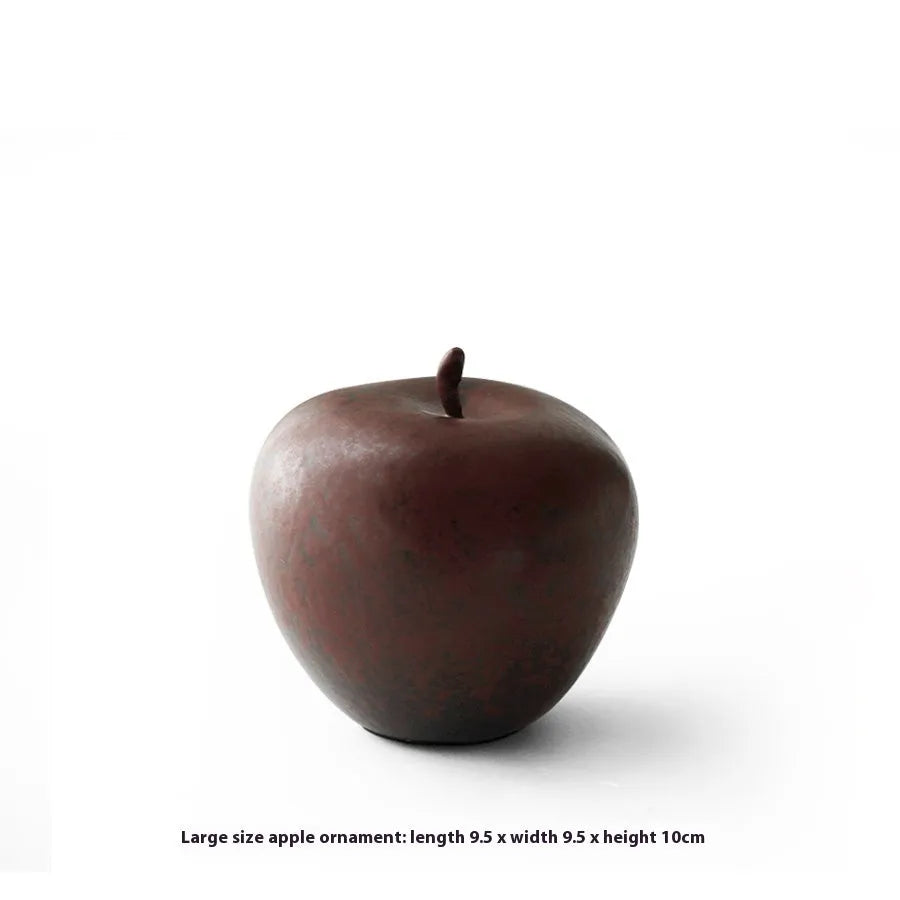 Retro style Chinese ceramic apple decoration ornament on a desktop.