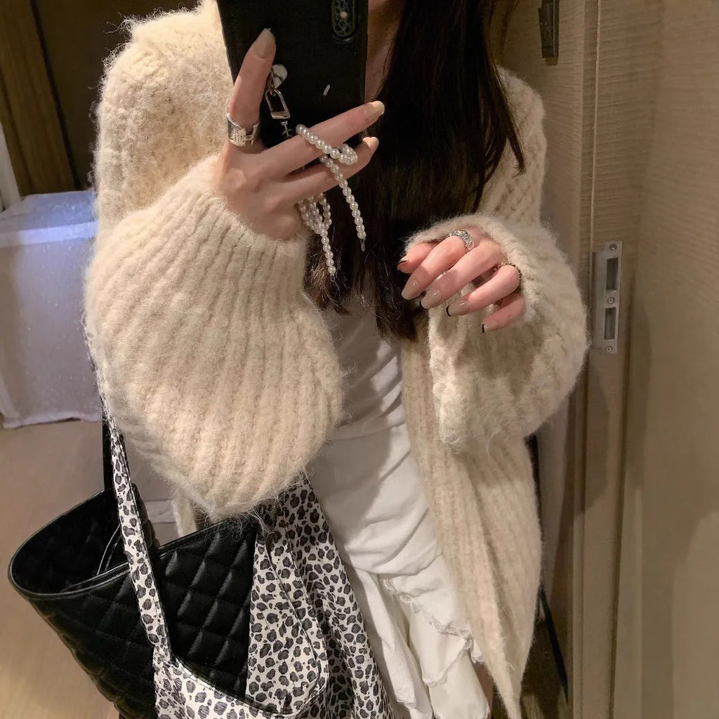 Woman wearing a brown retro-style Maillard hooded cardigan with a thick knit and loose fit.