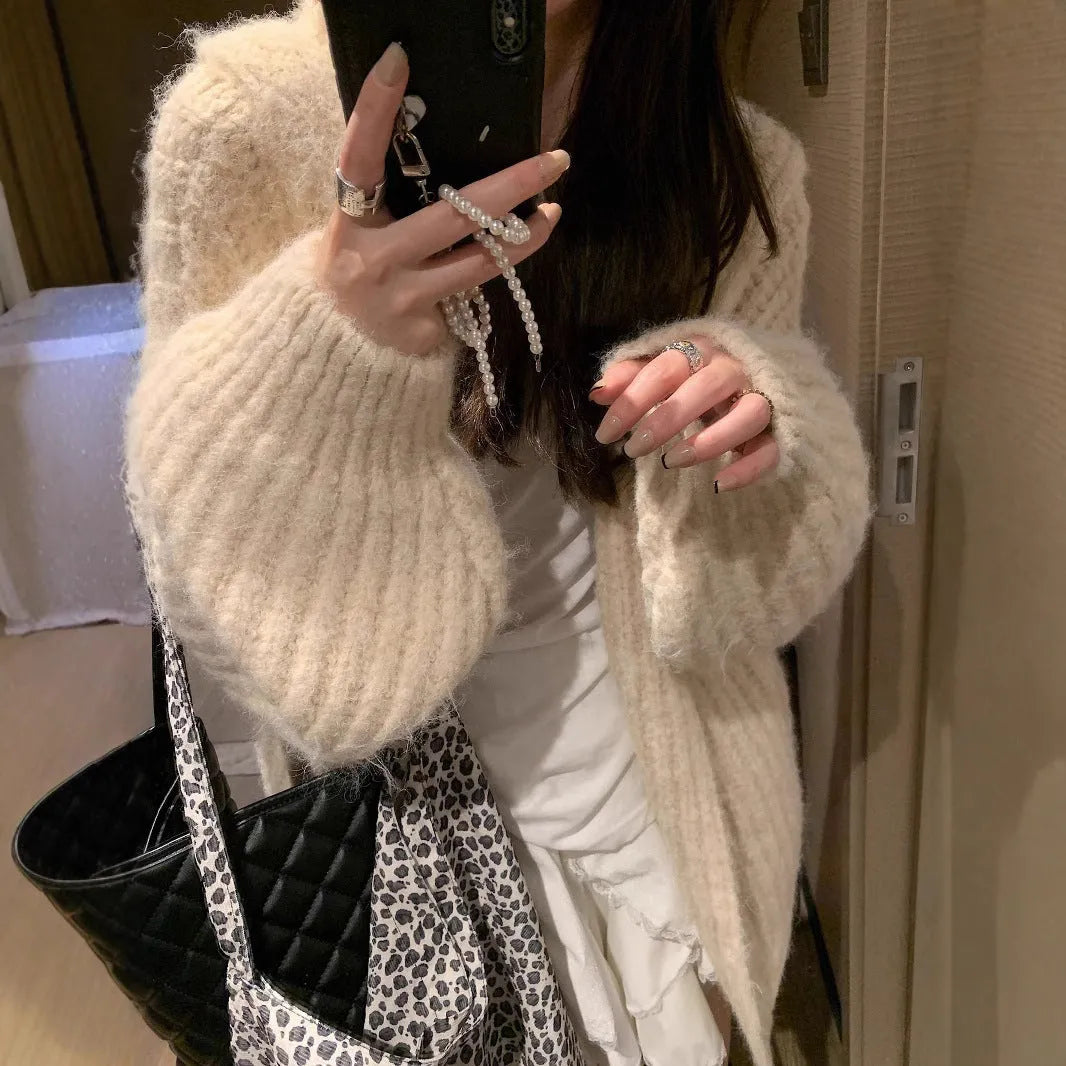 Woman wearing a brown retro-style Maillard hooded cardigan with a thick knit and loose fit.