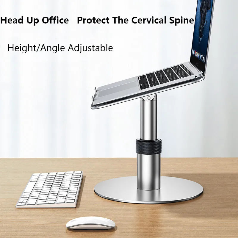 Silver aluminium adjustable laptop stand with rotating base and non-slip pads on a desk.