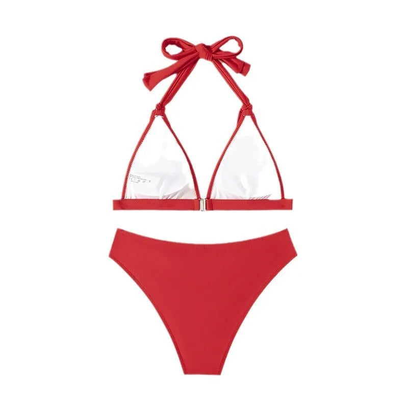 Red women's bikini set with lace-up halterneck top and matching split shorts on a mannequin.