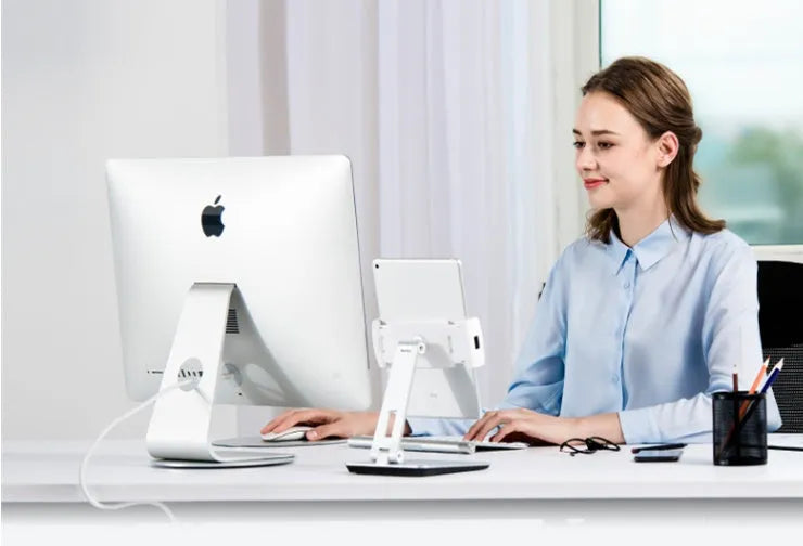 Silver folding aluminium phone and tablet stand with 360-degree rotation on desktop