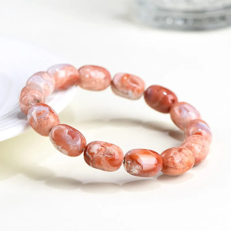 Natural cherry blossom coloured agate barrel bead bracelet with a Ruyi charm.