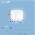 Square LED cube stool light in garden setting showing modern design with lighting