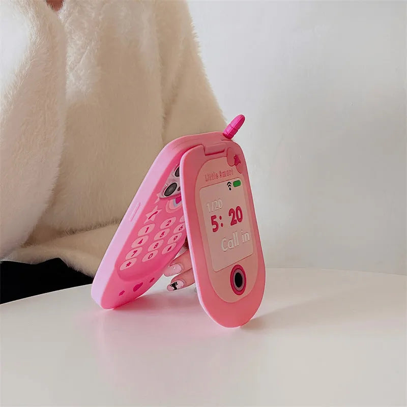Light pink silicone flip phone case with built-in mirror for iPhone, showing cute cartoon design
