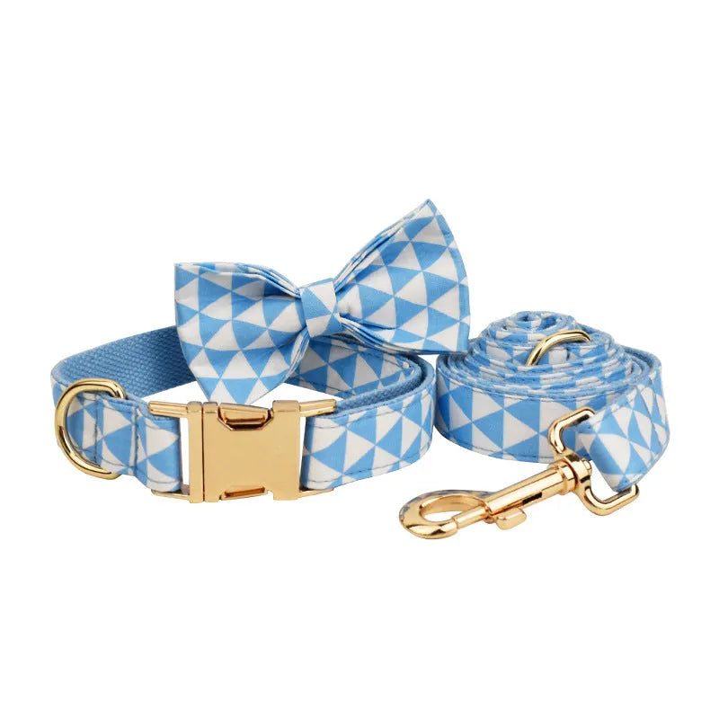 Blue triangular ring pattern dog accessory set with collar, leash, bow, and vest