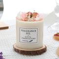 Scented aromatherapy candle with dried flowers inside, shown with optional wooden chip base and gift box packaging.