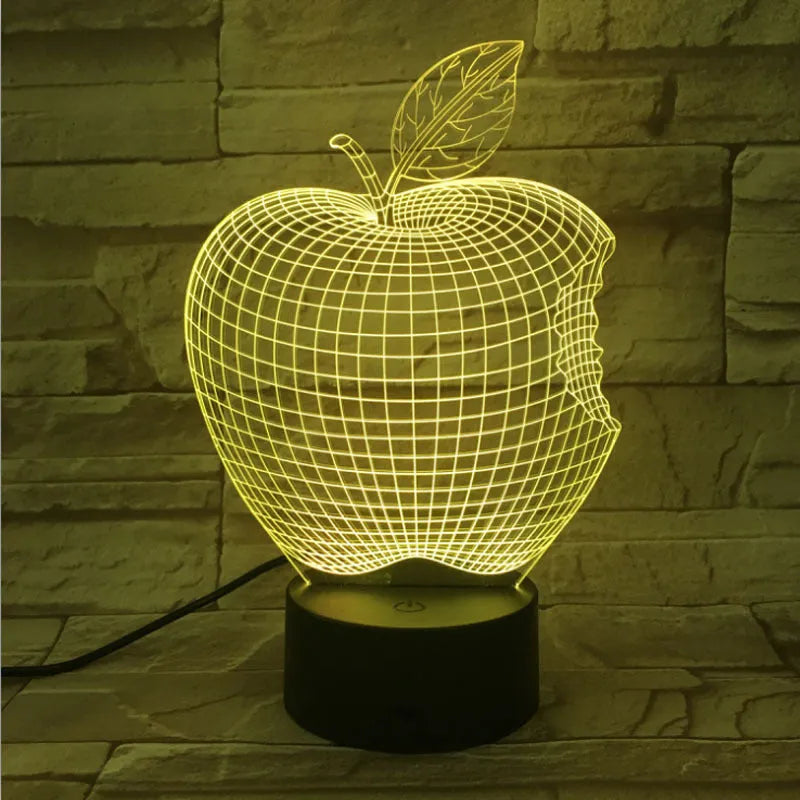 Colourful 3D fruit shaped acrylic LED night light with touch control on a table.