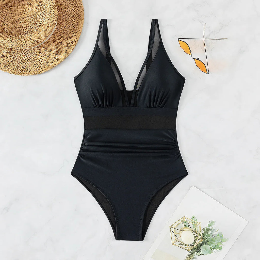 Black halter neck one-piece swimsuit for women, briefs style, made from nylon fabric.