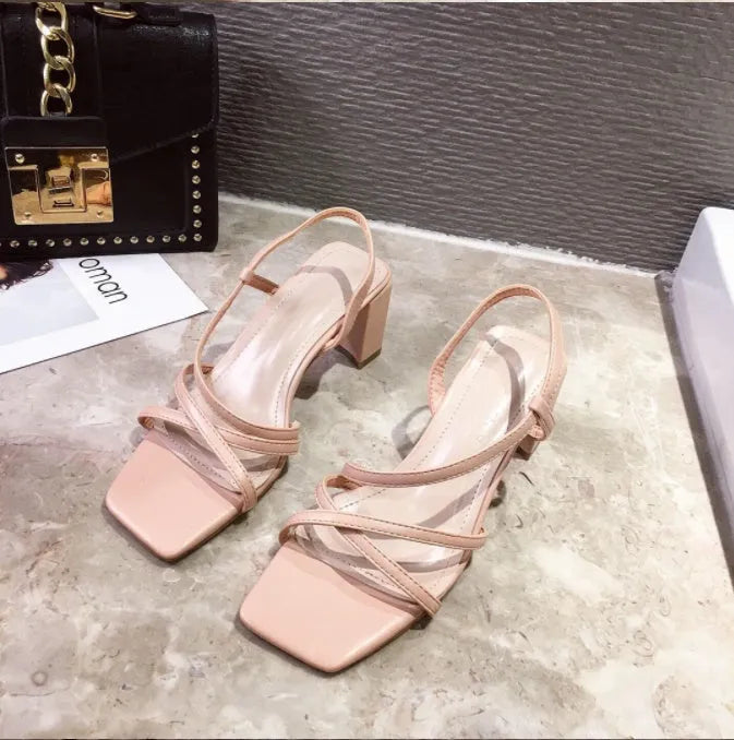 Women's white thick-heeled platform sandals with a slide-on design and low-cut upper.