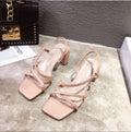 Women's white thick-heeled platform sandals with a slide-on design and low-cut upper.