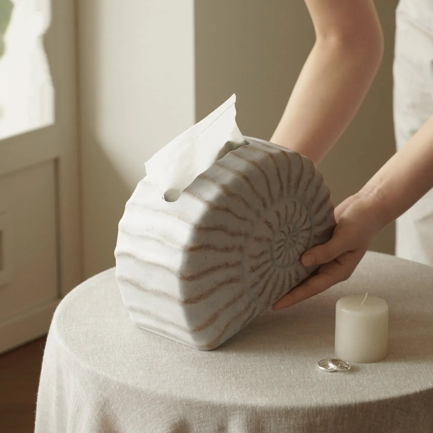 Modern conch shell shaped resin tissue box cover in a conch ramble colour.