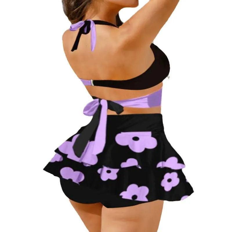 Purple women's bikini with lace-up detail and matching high-waisted split skirt