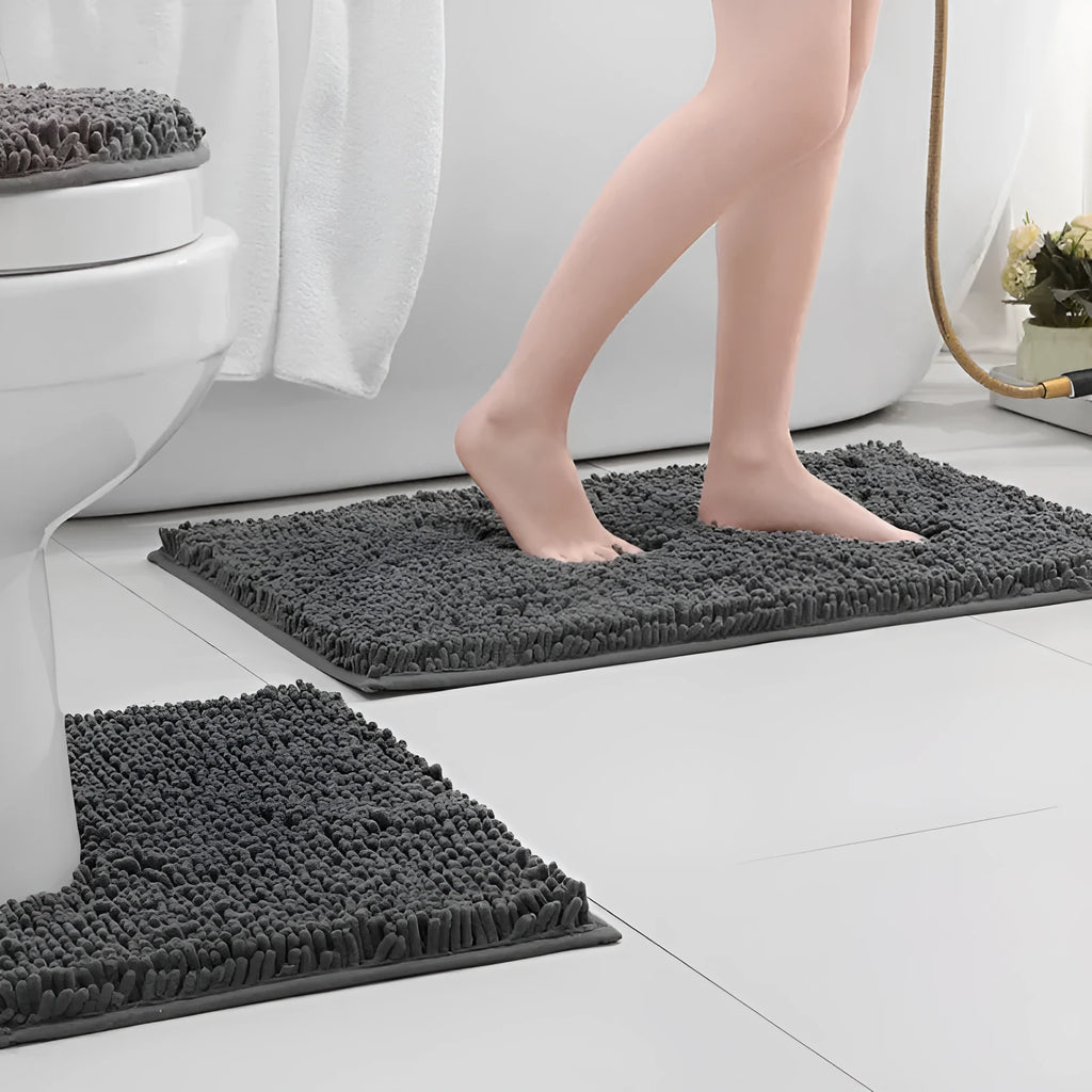 Dark green chenille three-piece U-shaped toilet mat set with non-slip TPR backing on bathroom floor.