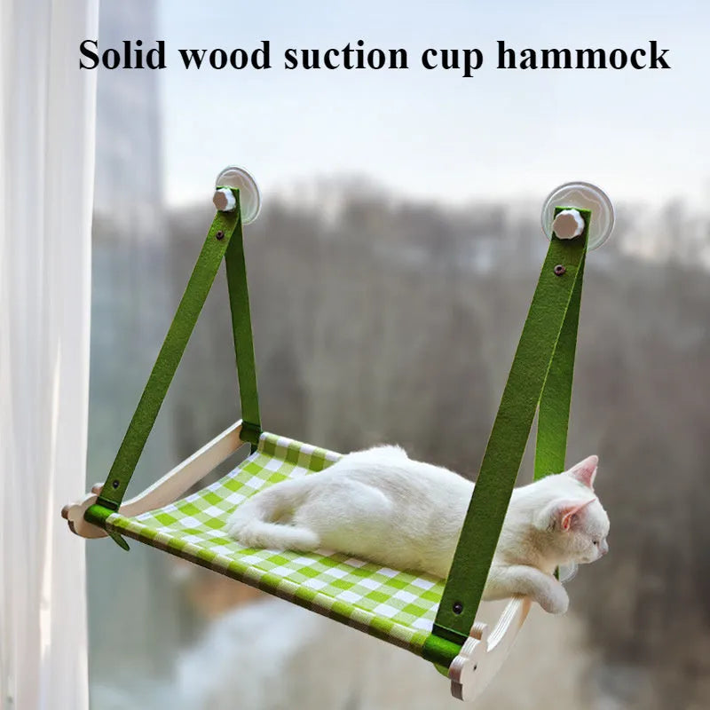 Wooden cat window hammock with suction cups on a glass window