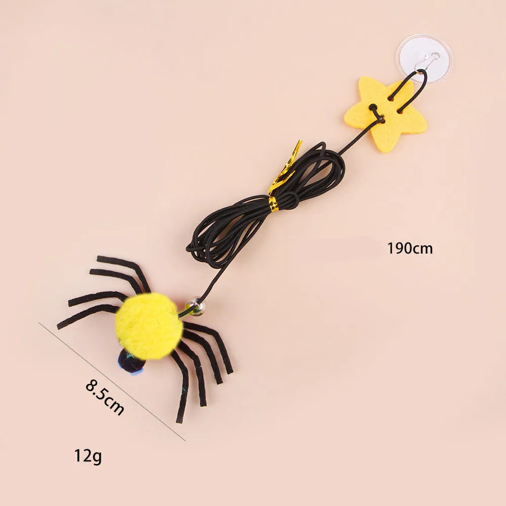 Red and yellow hanging door cat toy with feather, bell, spider, and elastic rope for interactive pet play