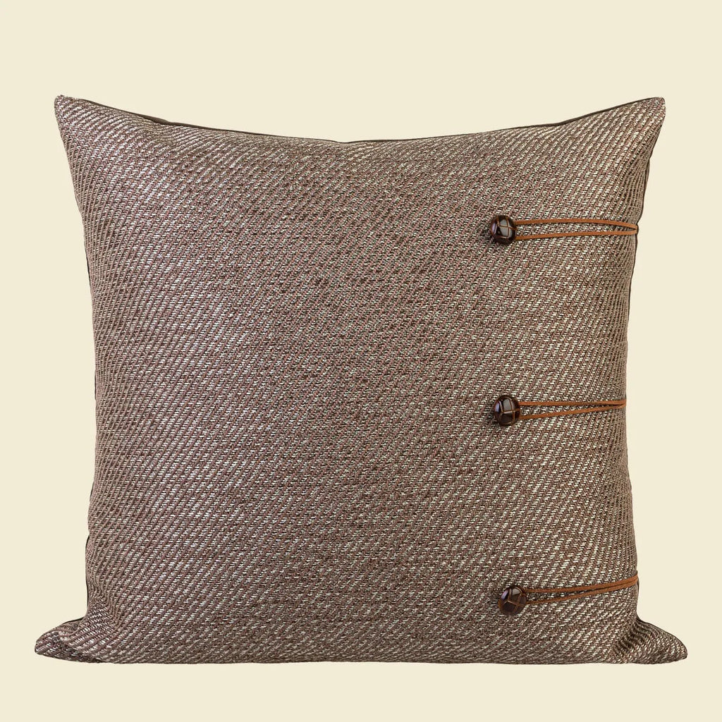 Chinese style square cushion with geometric pattern in Maillard brown colour on a sofa.