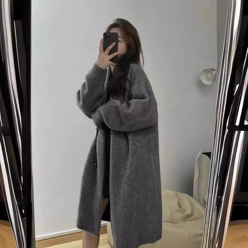 Women's loose-fit mid-length knitted cardigan in grey, showing V-neck and long sleeves.