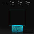 3D acrylic LED message board night light with remote control and marker pen on a desk.
