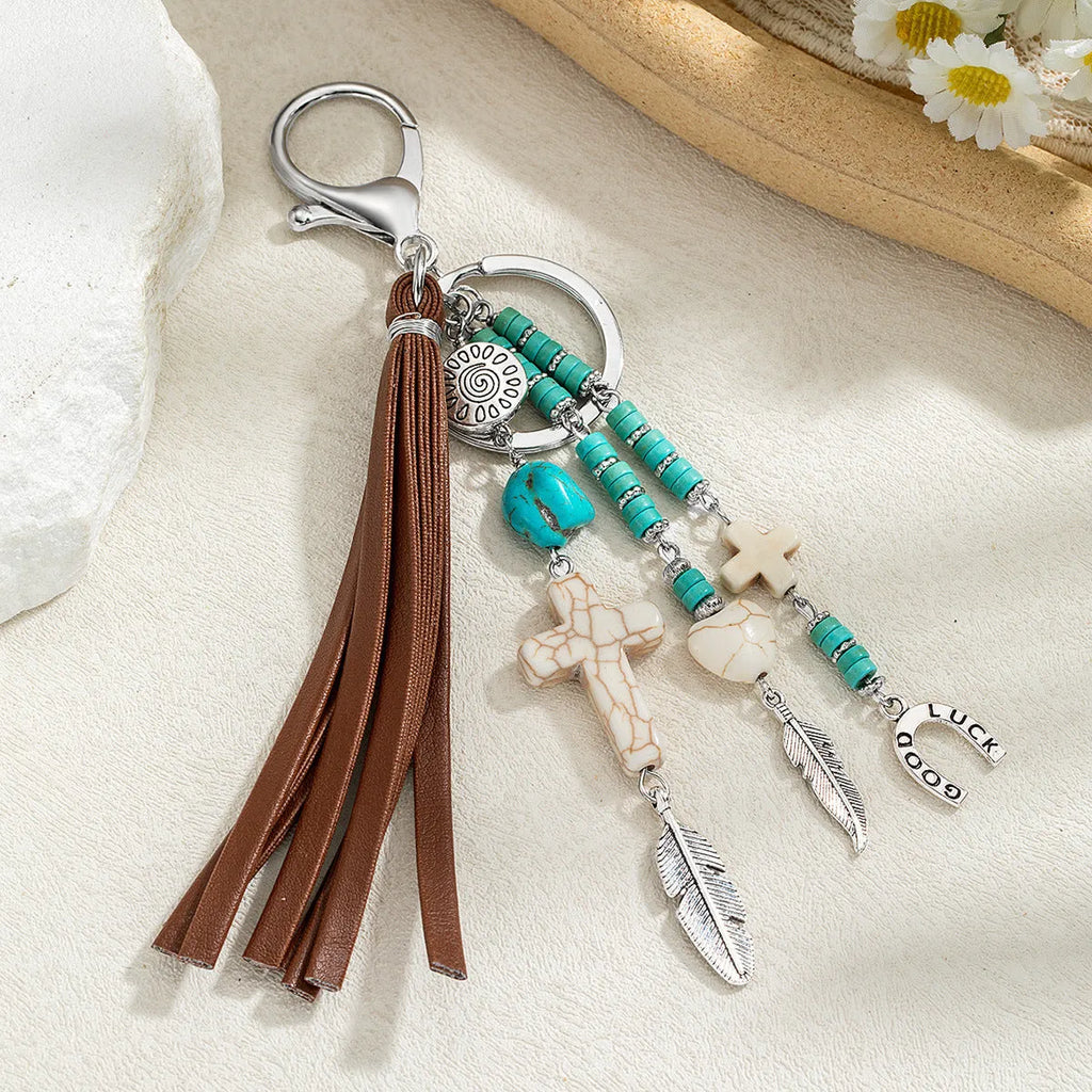 Cross alloy leather tassel pendant keychain in retro style, colour XY-3669, on a neutral background