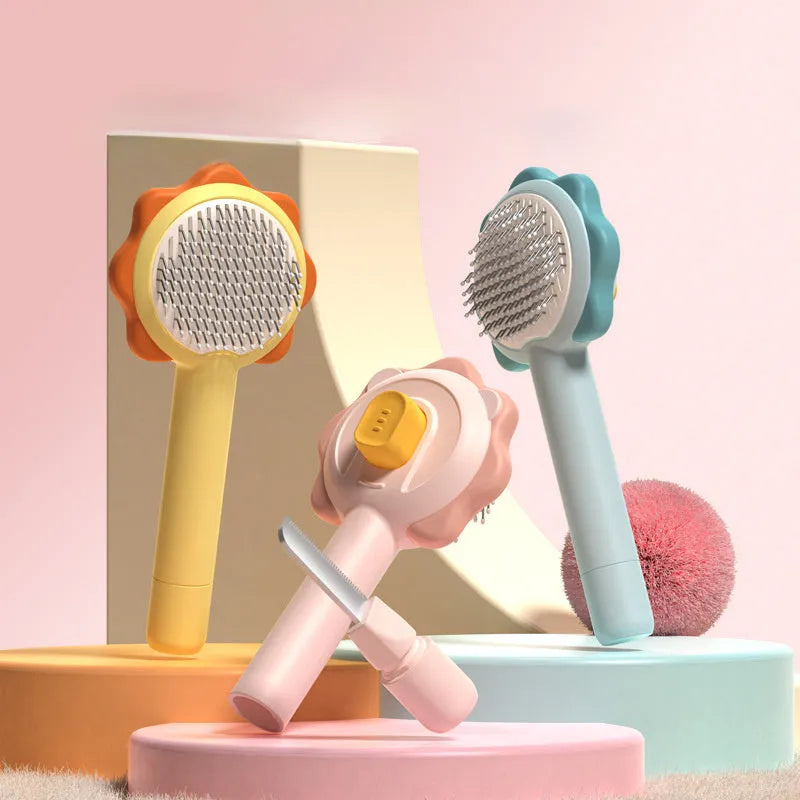 Stainless steel pet comb with one-click hair removal in blue, pink, and yellow colours on white background