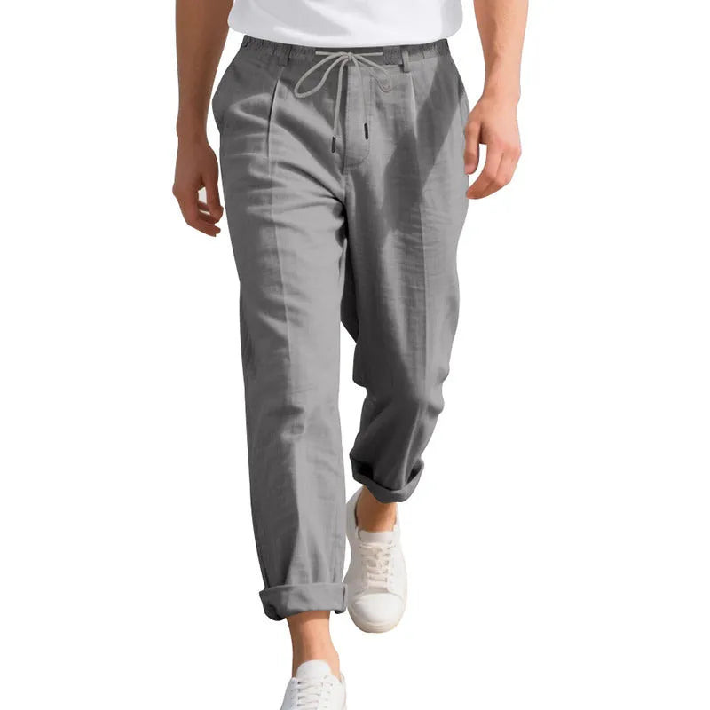 Men's light khaki linen casual trousers with a drawstring waistband and straight-leg silhouette.