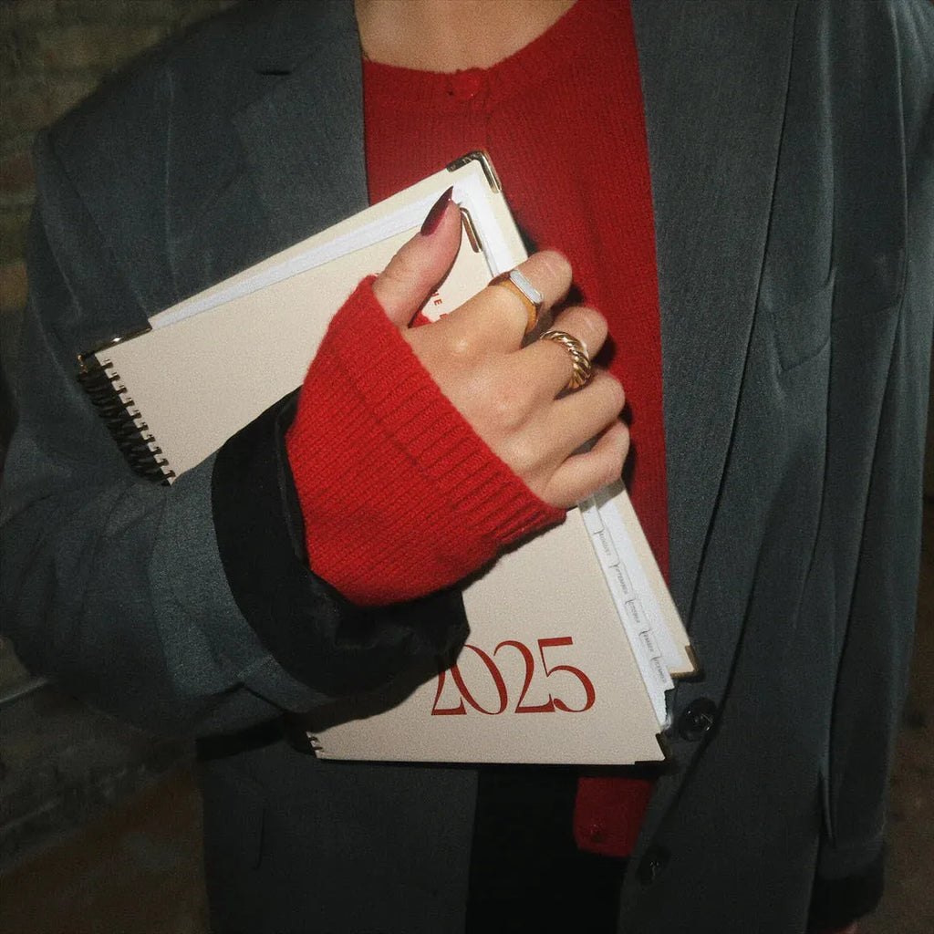 Cherry Red daily schedule coil notebook with spiral binding open to show interior pages