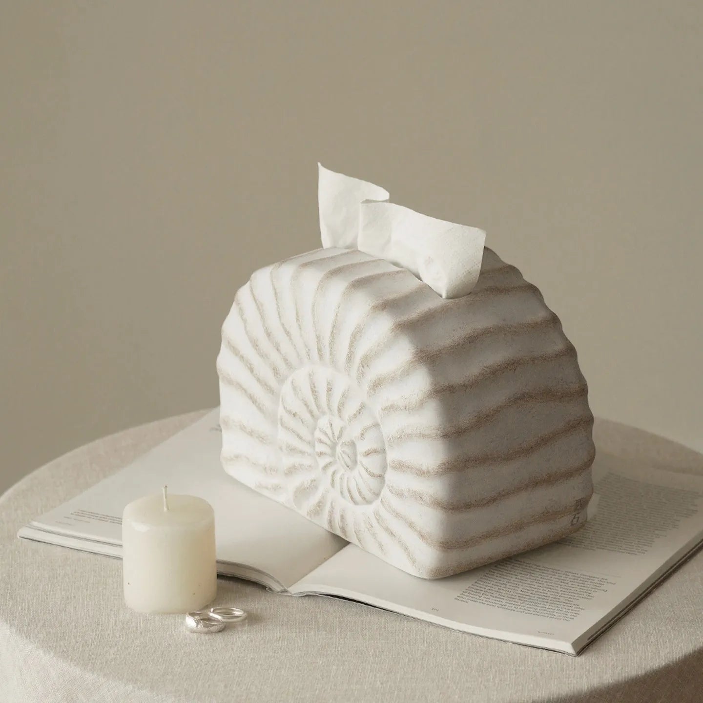Modern conch shell shaped resin tissue box cover in a conch ramble colour.