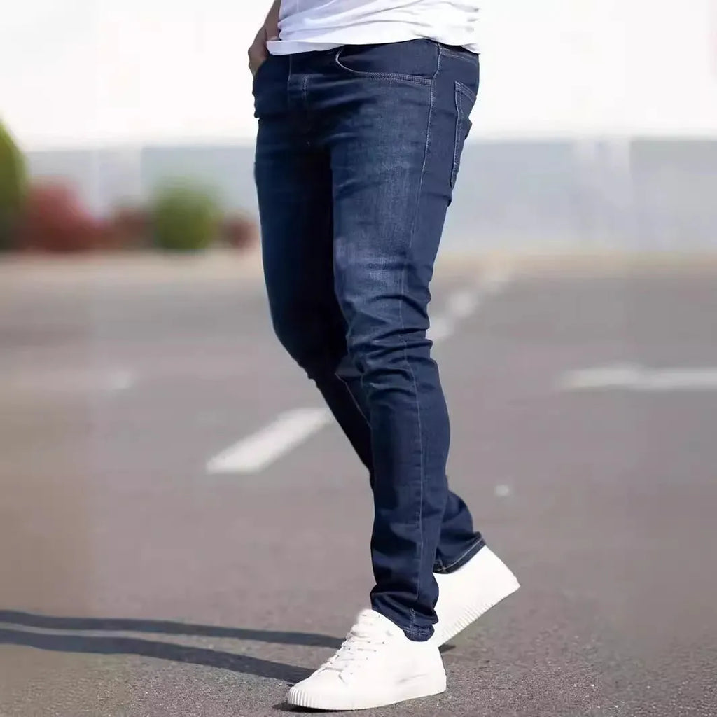 Dark blue men's slim fit casual jeans with mid waist and skinny leg style.