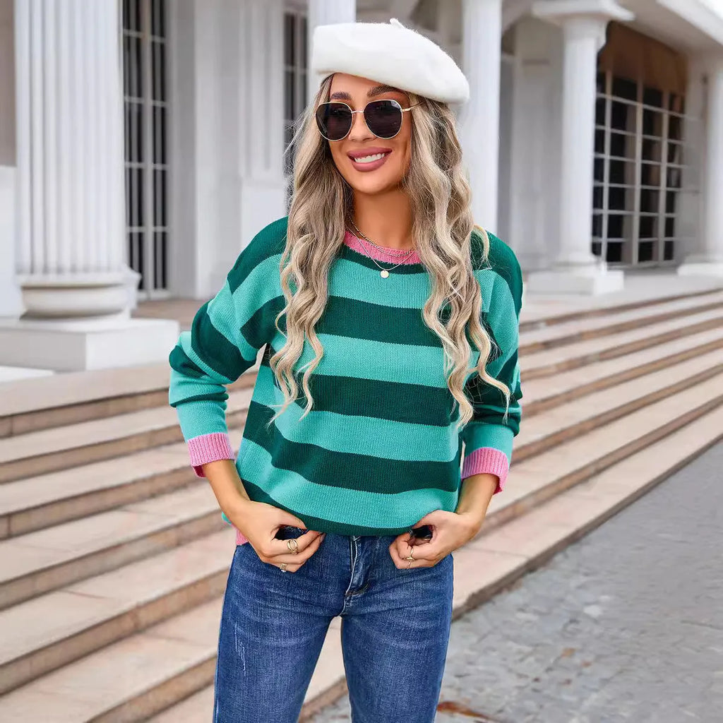 Blue striped women's loose-fit long sleeve acrylic sweater on a hanger.