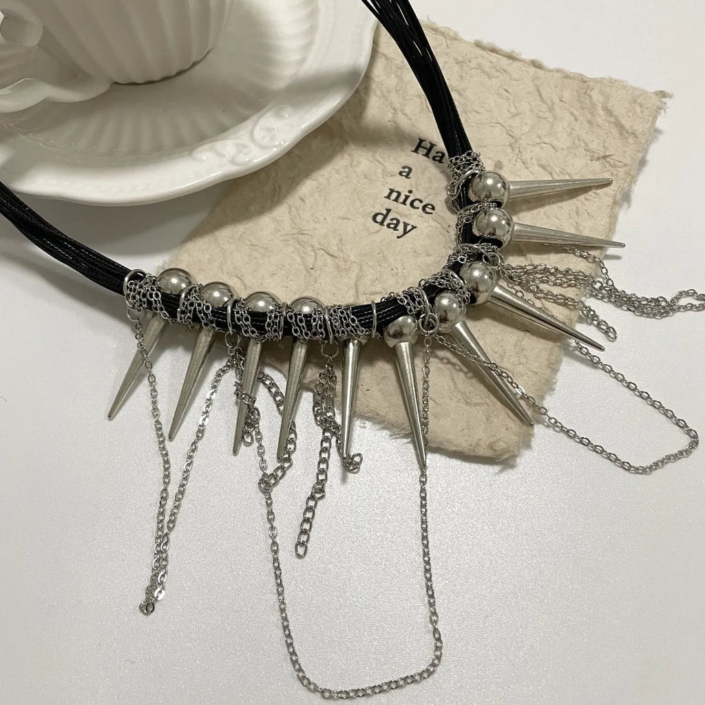 Women's leather necklace with electroplated rivets and a winding beaded tassel pendant