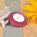A roll of colourful green onion pattern polyester ribbon with metallic wire highlights, shown at 3-points width.