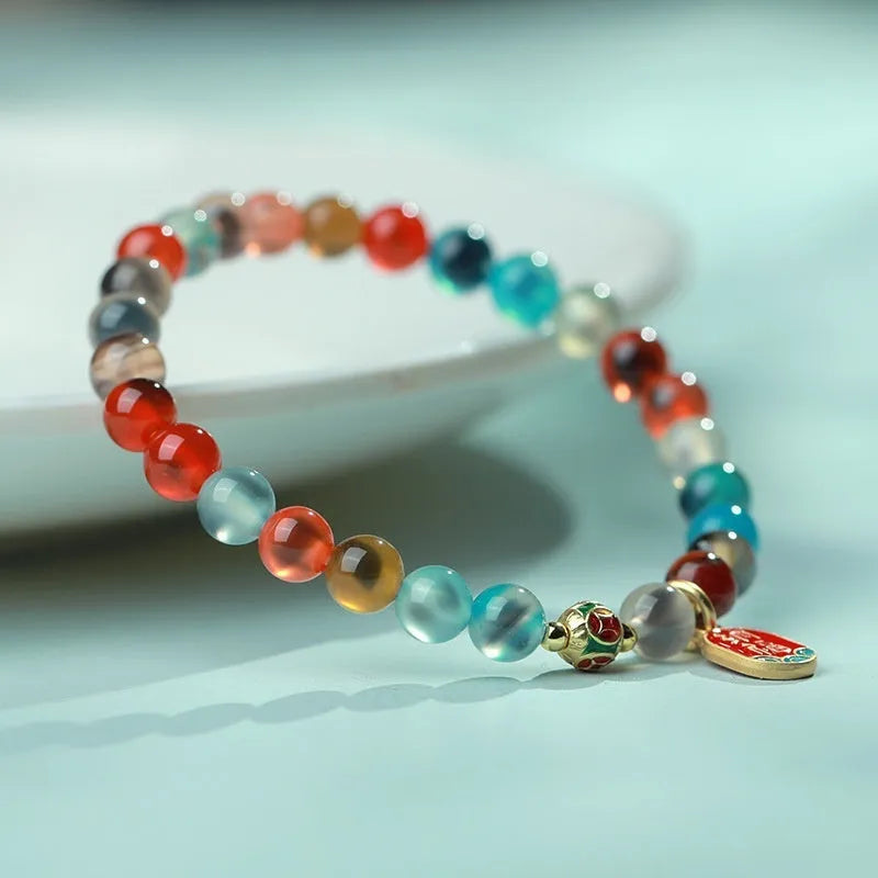 Women's geometric bracelet with colourful sugar heart agate beads and a detailed copper coin snake chain.