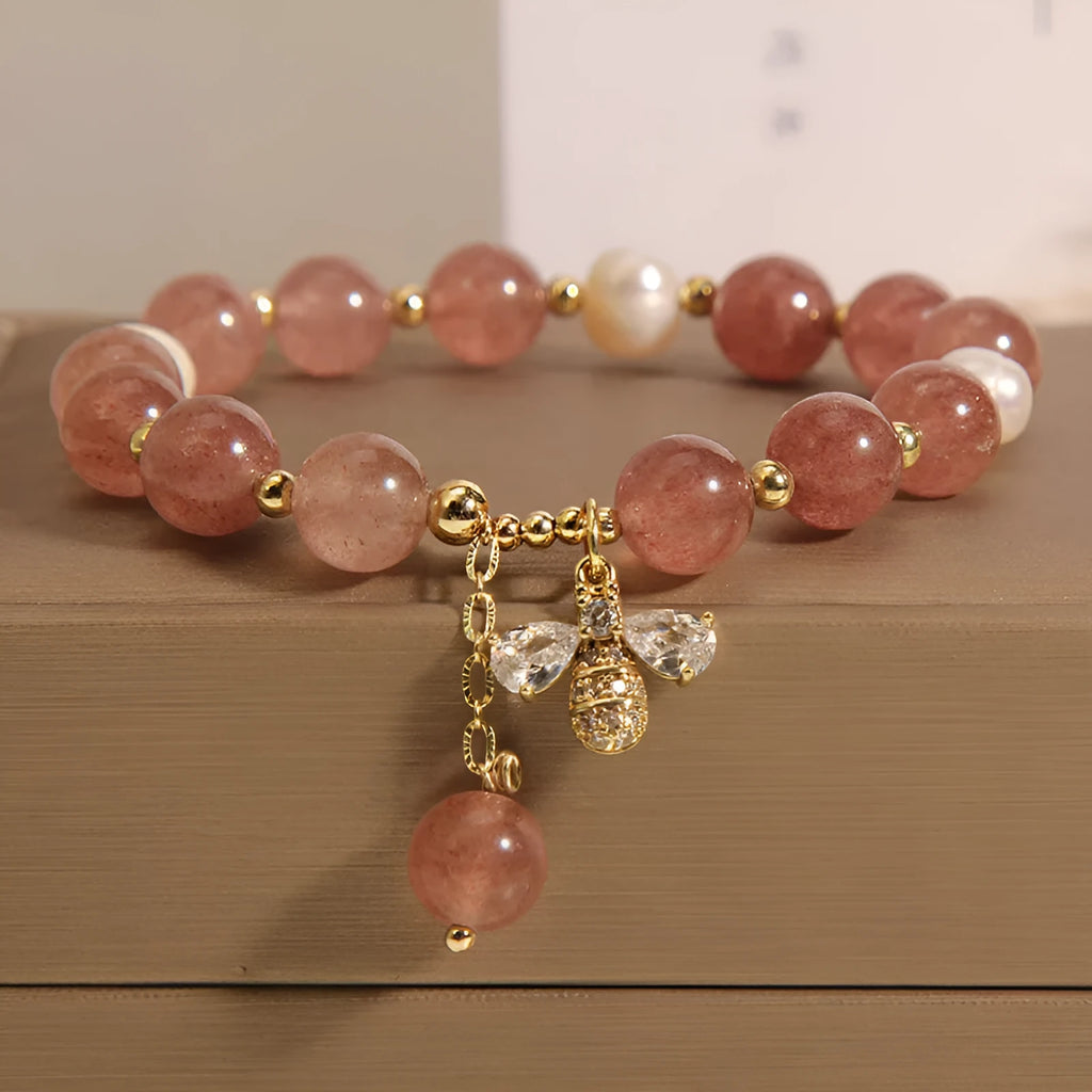 Women's bracelet with strawberry quartz stones, freshwater pearls, and zircon accents on an alloy chain.