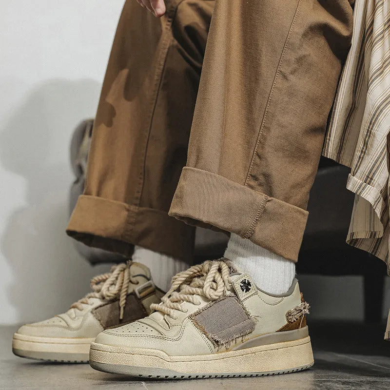 Beige low-top vintage skate shoes with lace-up front and rubber sole.
