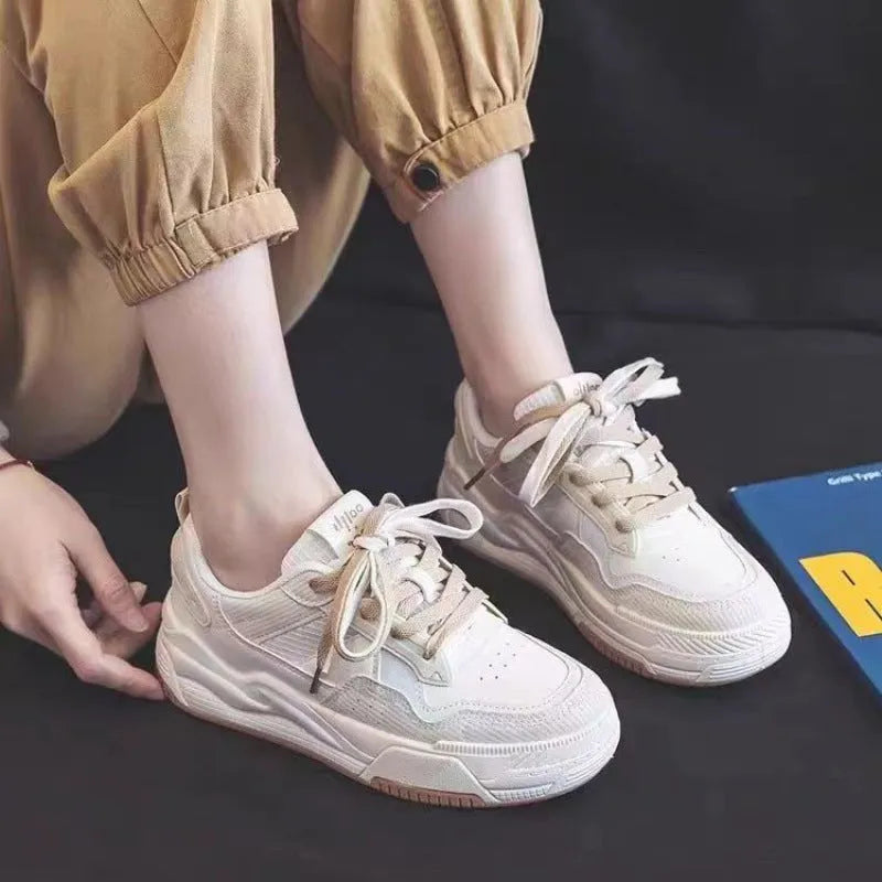 Women's pink low-top sneakers with imitation leather upper and rubber sole for hidden height increase.