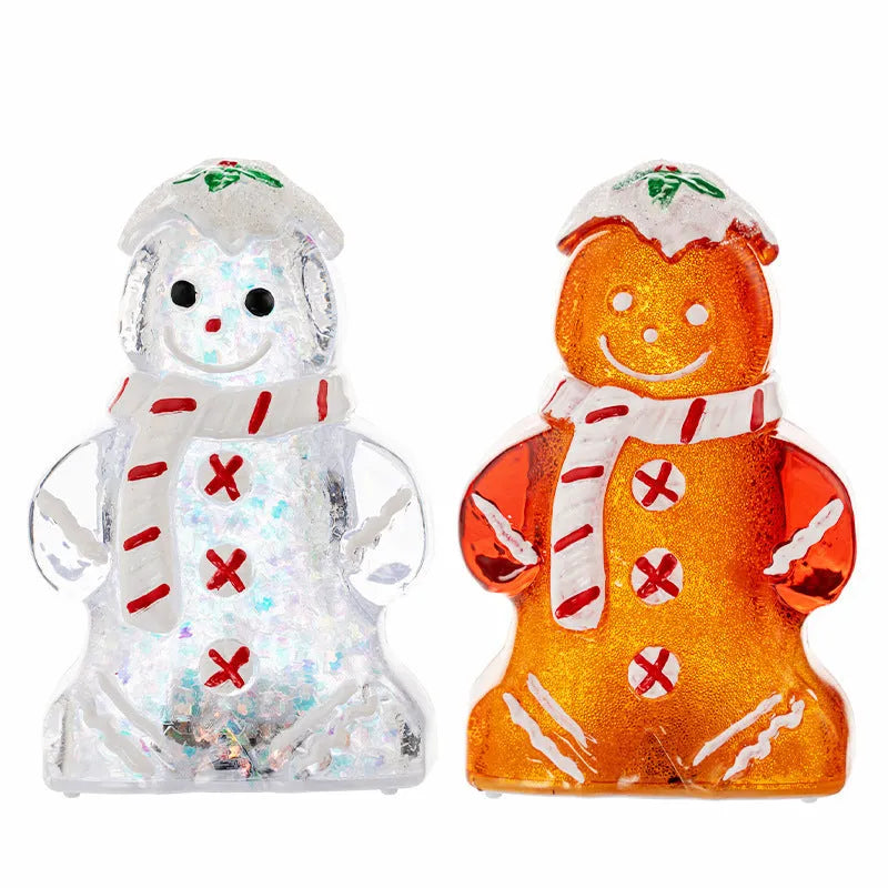 Glowing LED gingerbread man and snowman Christmas ornaments with coloured scarves on a festive tree branch.