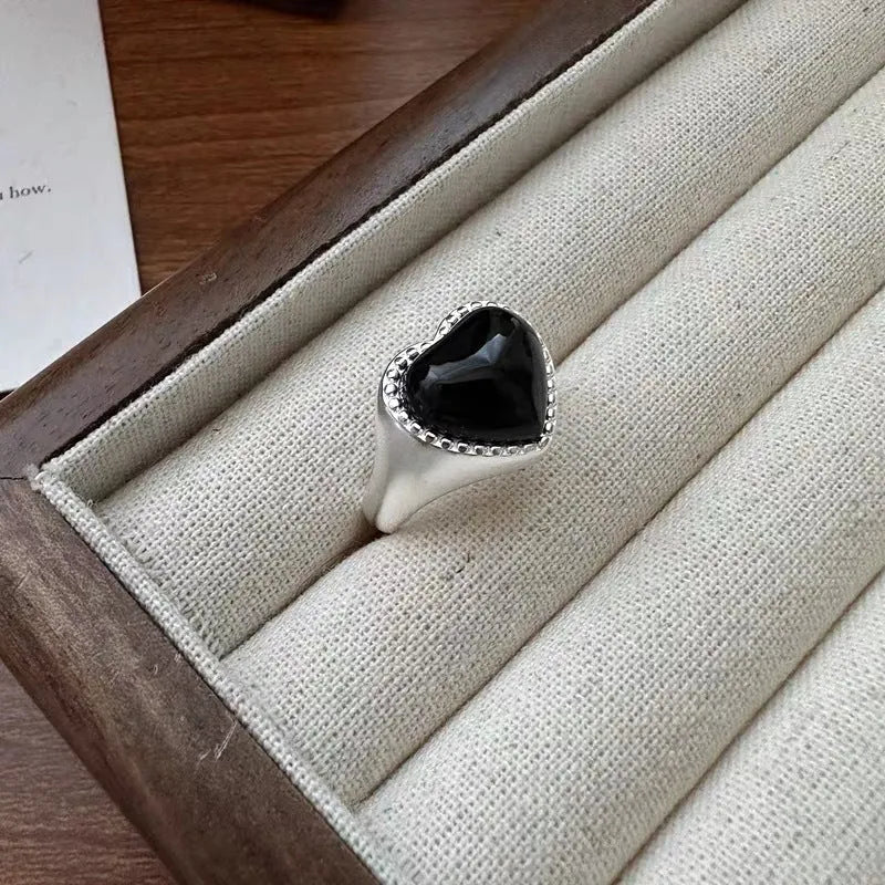 S925 sterling silver ring with black agate heart on adjustable open band.
