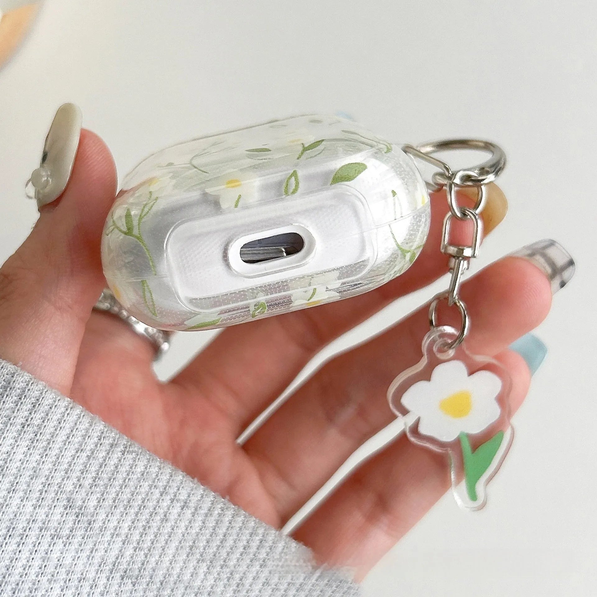 White floral patterned transparent TPU protective cover for Apple AirPods showing compatibility with multiple models
