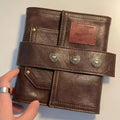 Brown retro-style A7 notebook with a leather buckle design and loose-leaf binding