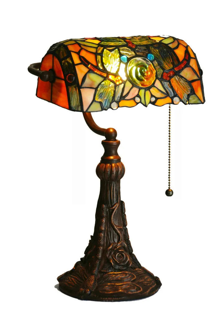 Tiffany style table lamp with coloured stained glass shade on a resin base.