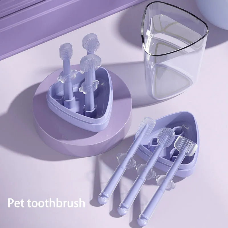 Soft silicone pet toothbrush for dogs and cats in purple, blue, and green colours with ergonomic handle.