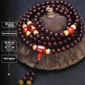 Men's rosewood 108-bead mala bracelet with detailed turquoise and silver beads on wrist.